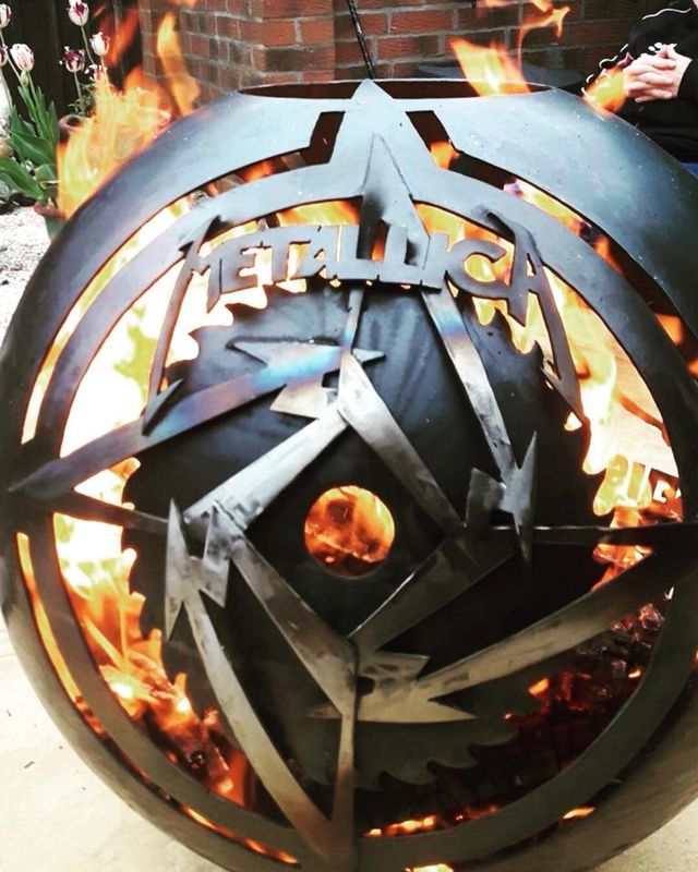 ROCK ANTHEMS GLOBE A totally personalised giant globe style wood burner which encompassed three logos....Metallica, AC/DC and the 'Three legs of Man'. Finished in an ultra-high temperature clear lacquer. 